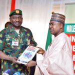 Chairman/Chief Executive Officer of the National Drug Law Enforcement Agency, NDLEA, Brig. Gen. Mohamed Buba Marwa (Retd) presenting a copy of the agency's official magazine to the Chief of Defence Staff, Gen. Christopher Musa when the latter paid him a courtesy visit at the NDLEA's national headquarters in Abuja on Monday 18th December 2023